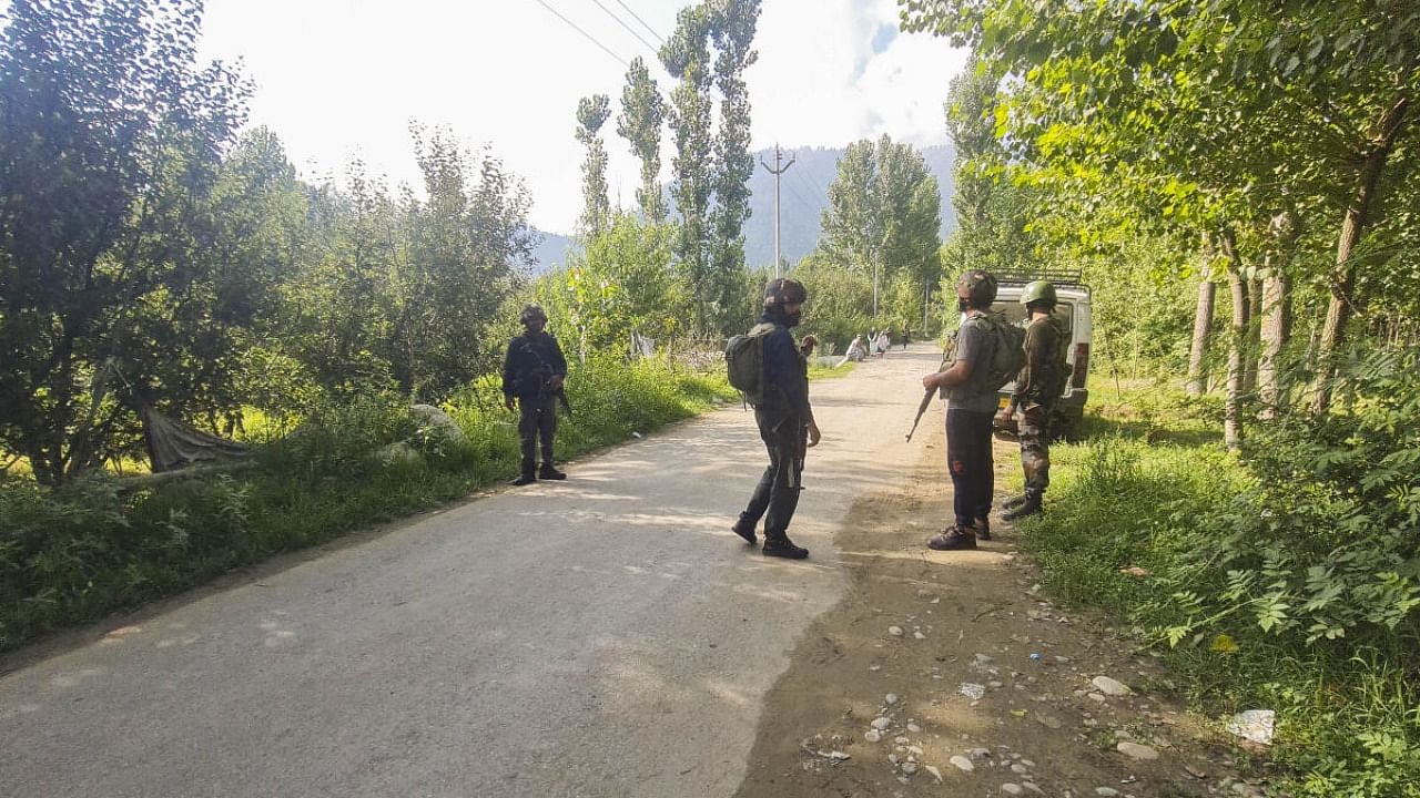 Security personnel during a cordon and search operation after an Army soldier on leave went missing, in Kulgam district. Credit: PTI Photo