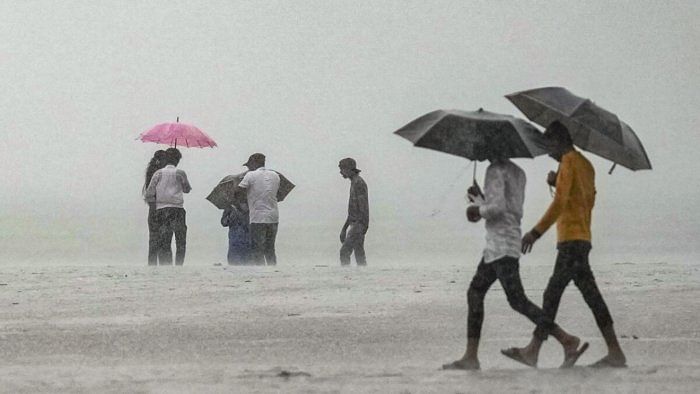 People during monsoon rains, in Mumbai, Wednesday, July 26, 2023. Credit: PTI Photo