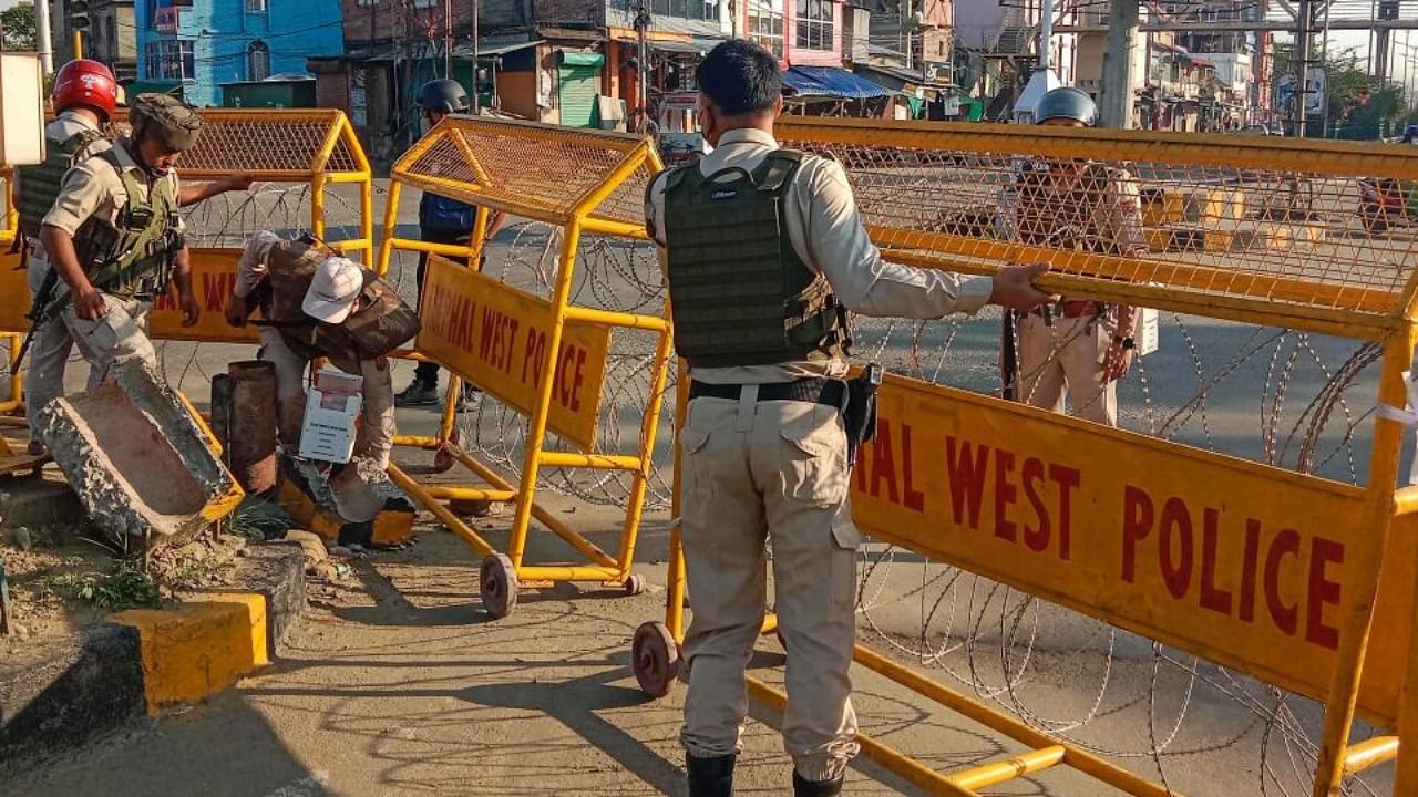 Police personnel stand guard in a violence-hit area of Imphal town, Manipur, Sunday, May 28, 2023. Credit: PTI Photo