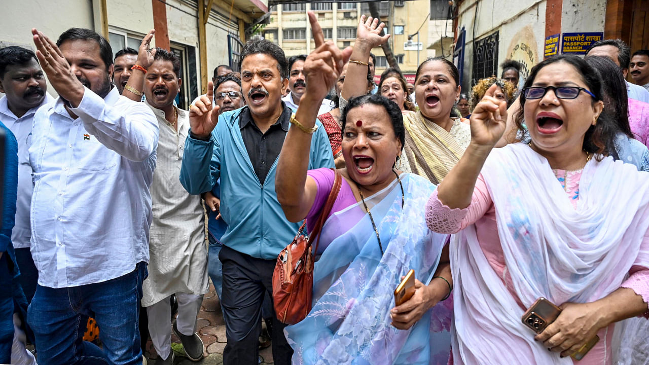 Congress leader Sanjay Nirupam and others raise slogans against right-wing activist Sambhaji Bhide over his alleged derogatory remarks about Mahatma Gandhi, outside Oshiwara police station in Mumbai. Credit: PTI Photo