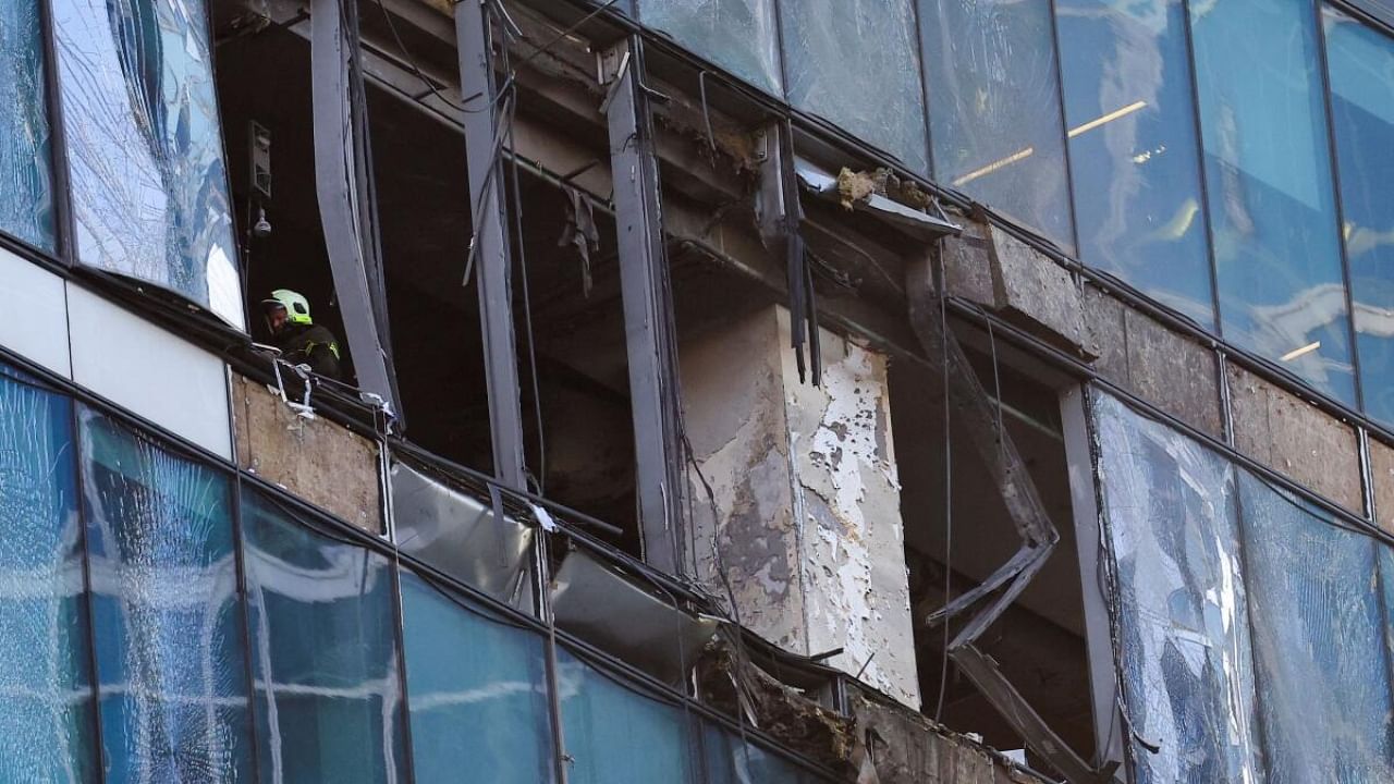 An emergency personnel works inside a damaged office building in the Moscow City following a reported Ukrainian drone attack in Moscow Russia. Credit: Reuters Photo