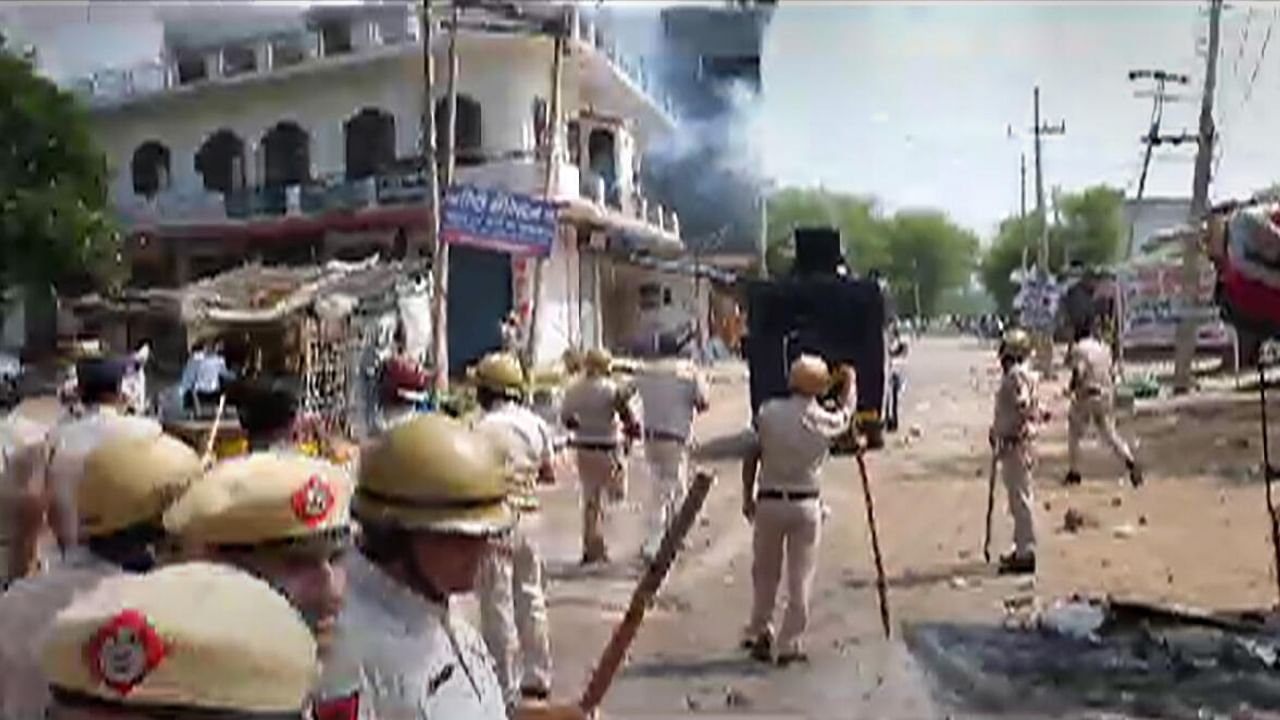 Security personnel attempt to disperse miscreants after stones were pelted at a 'Brij Mandal Jalabhishek Yatra', in Nuh, Monday, July 31, 2023.. Credit: PTI Photo