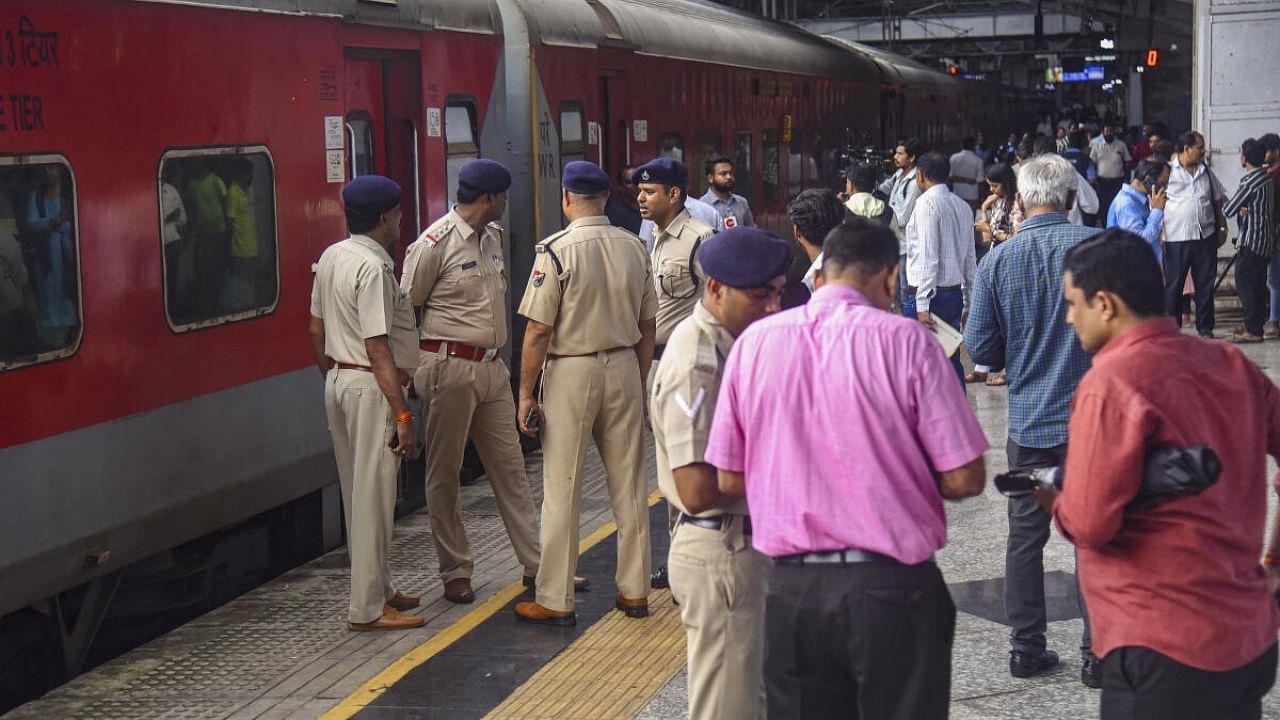 Police personnel inspect the Jaipur-Mumbai Central Express on board which a Railway Protection Force (RPF) jawan shot dead four people near Palghar railway station. Credit: PTI Photo