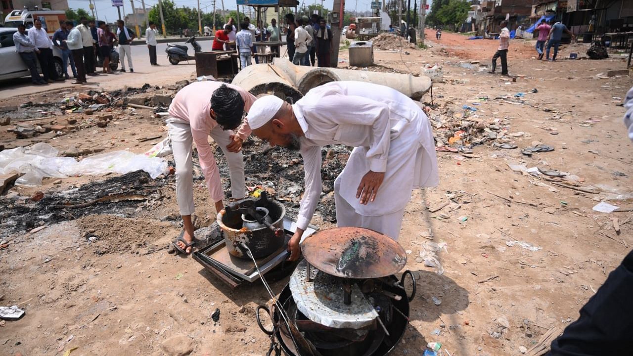 People retrieve their belongings after communal clashes, near Ambedkar Chowk at Sohna, in Gurugram district, Tuesday, Aug. 1, 2023. Credit: PTI Photo