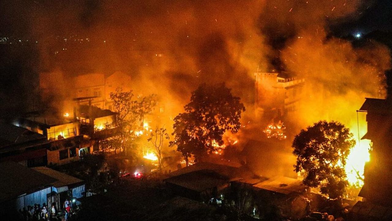 Smoke and flame billows out after the houses of Kuki-Zo community were set on fire by miscreants in the violence-hit Manipur, in imphal, Tuesday, Aug 1, 2023. Credit: PTI Photo