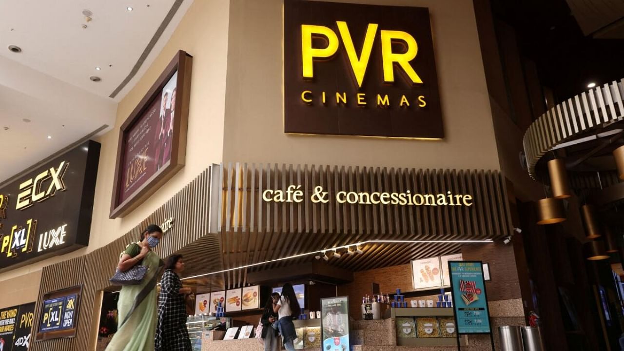 Women walk outside a PVR movie theatre in Mumbai. Credit: Reuters Photo