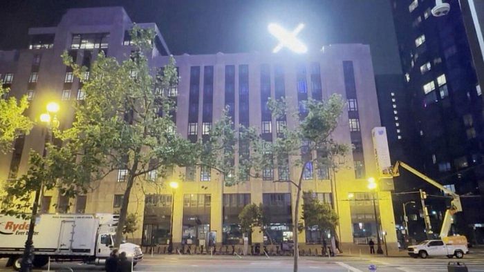 A crew works to remove the Twitter sign as an illuminated 'X' logo is seen on top of the building in San Francisco, California, US, July 29, 2023, in this screen grab obtained from a video. Credit: Reuters Photo