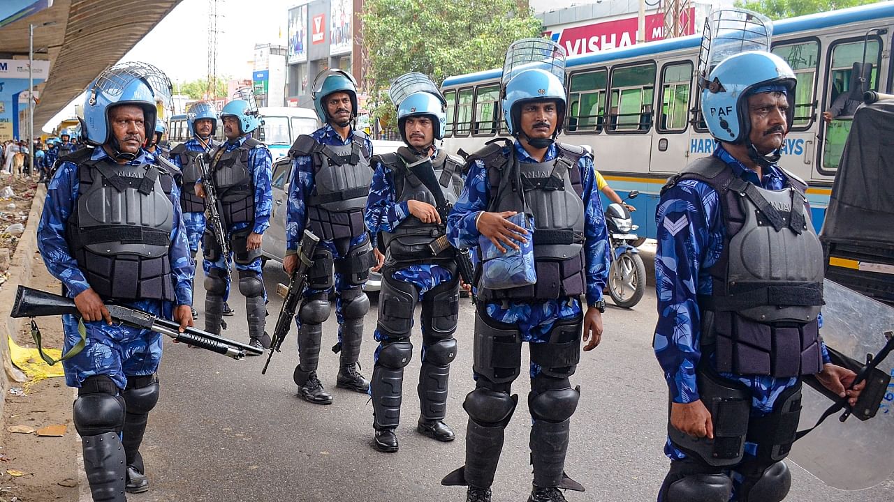 Rapid Action Force (RAF) personnel conduct a flag march at Badshahpur after incidents of violence following Monday's attack on a procession in adjoining Nuh district, in Gurugram district, Wednesday, August 2, 2023. Credit: PTI Photo