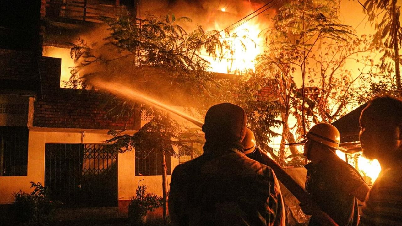 Firefighters try to douse a fire that was set in the houses of Kuki-Zo community by miscreants in the violence-hit Manipur, in imphal, Tuesday, Aug 1, 2023. The fire also engulfed more than a dozen houses of migrants from Bihar, Haryana, and Naga people. Credit: PTI Photo