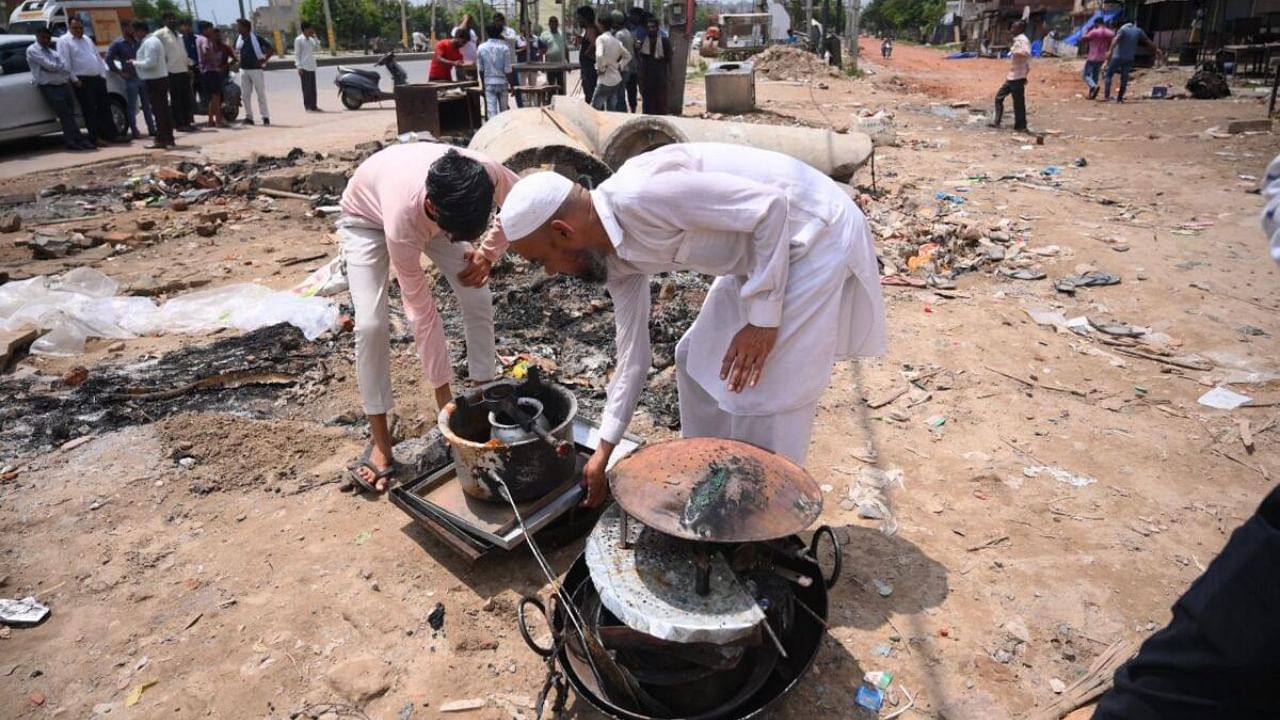 People retrieve their belongings after communal clashes, near Ambedkar Chowk at Sohna, in Gurugram district, Tuesday, Aug. 1, 2023. Credit: PTI Photo