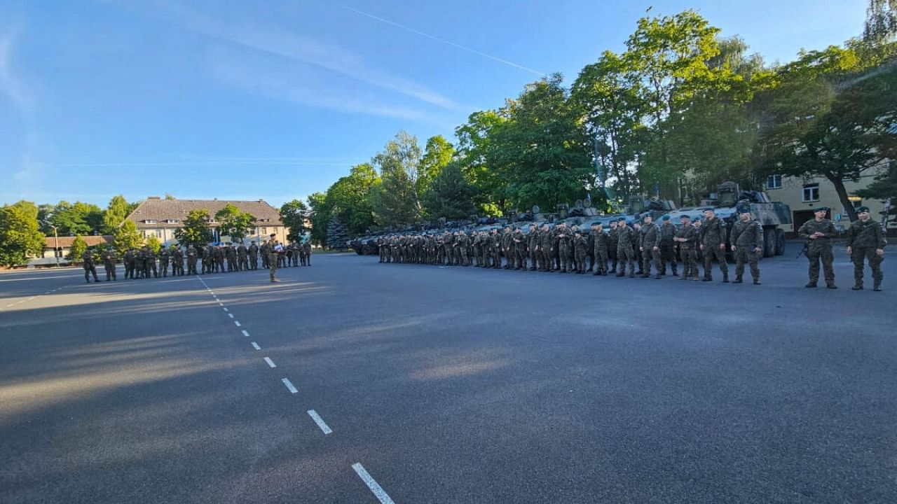 Polish army troops stand guard, as part of the 12th and 17th Mechanized Brigades are starting to move to the east of the country, in Poland, July 8, 2023. Credit: Reuters Photo