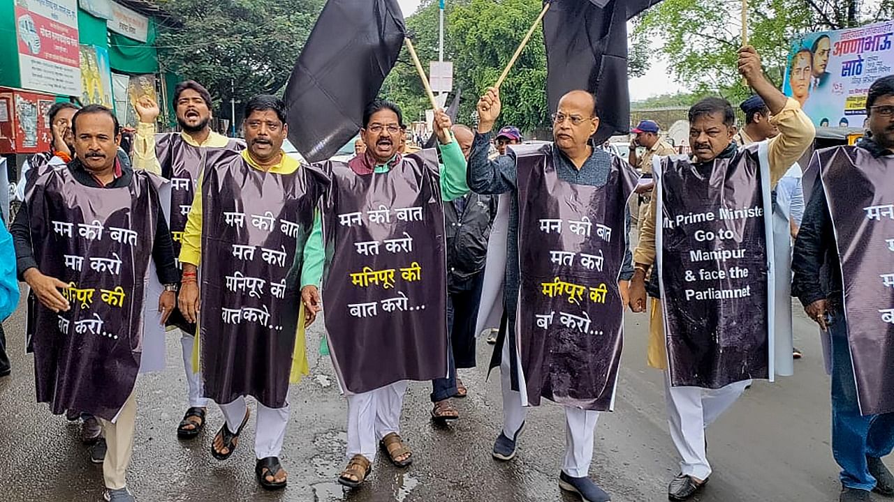 Congress and other opposition party workers raise slogans during a protest against Prime Minister Narendra Modi during his visit to the city, in Pune. Credit: PTI Photo