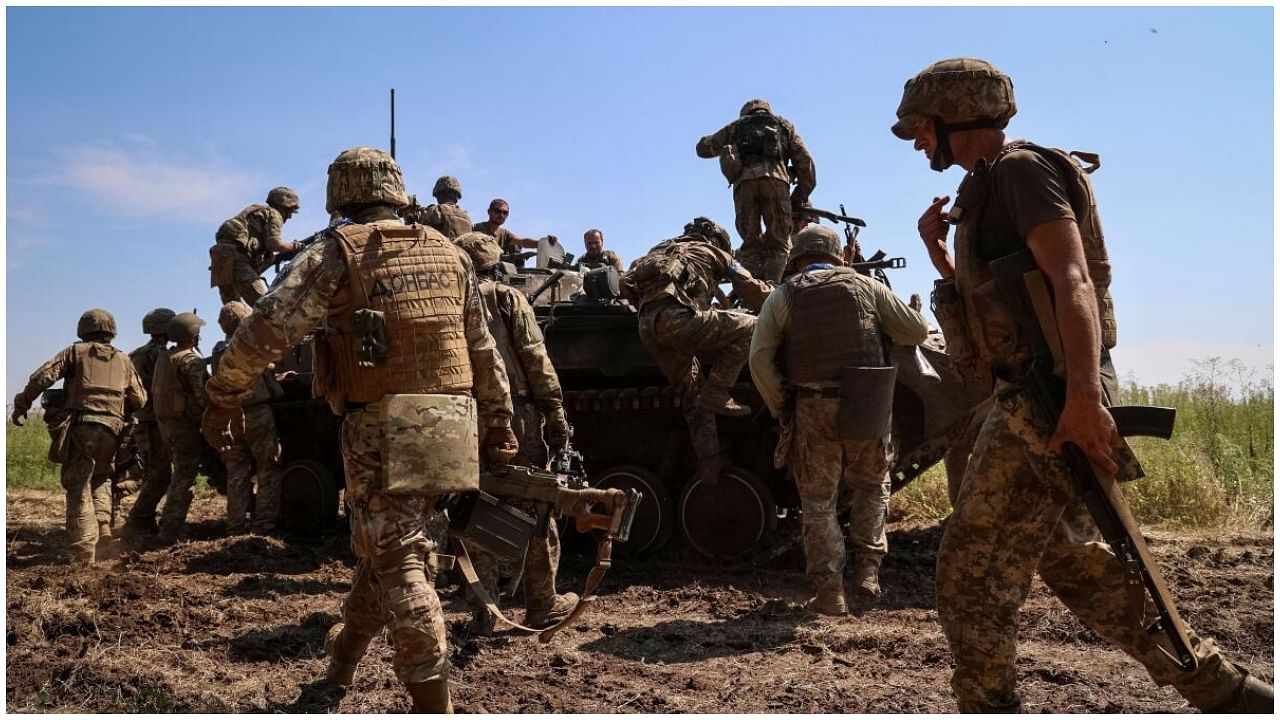 Ukrainian service members climb a BMP-2 infantry fighting vehicle, amid Russia's attack on Ukraine, in Zaporizhzhia region, Ukraine July 31, 2023. Credit: Reuters Photo