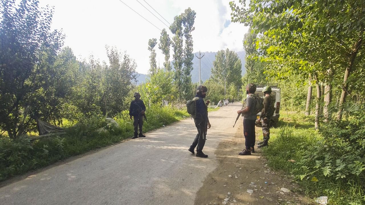 Security personnel during a cordon and search operation after an Army soldier on leave went missing, in Kulgam district, Sunday, July 30, 2023. Credit: PTI Photo