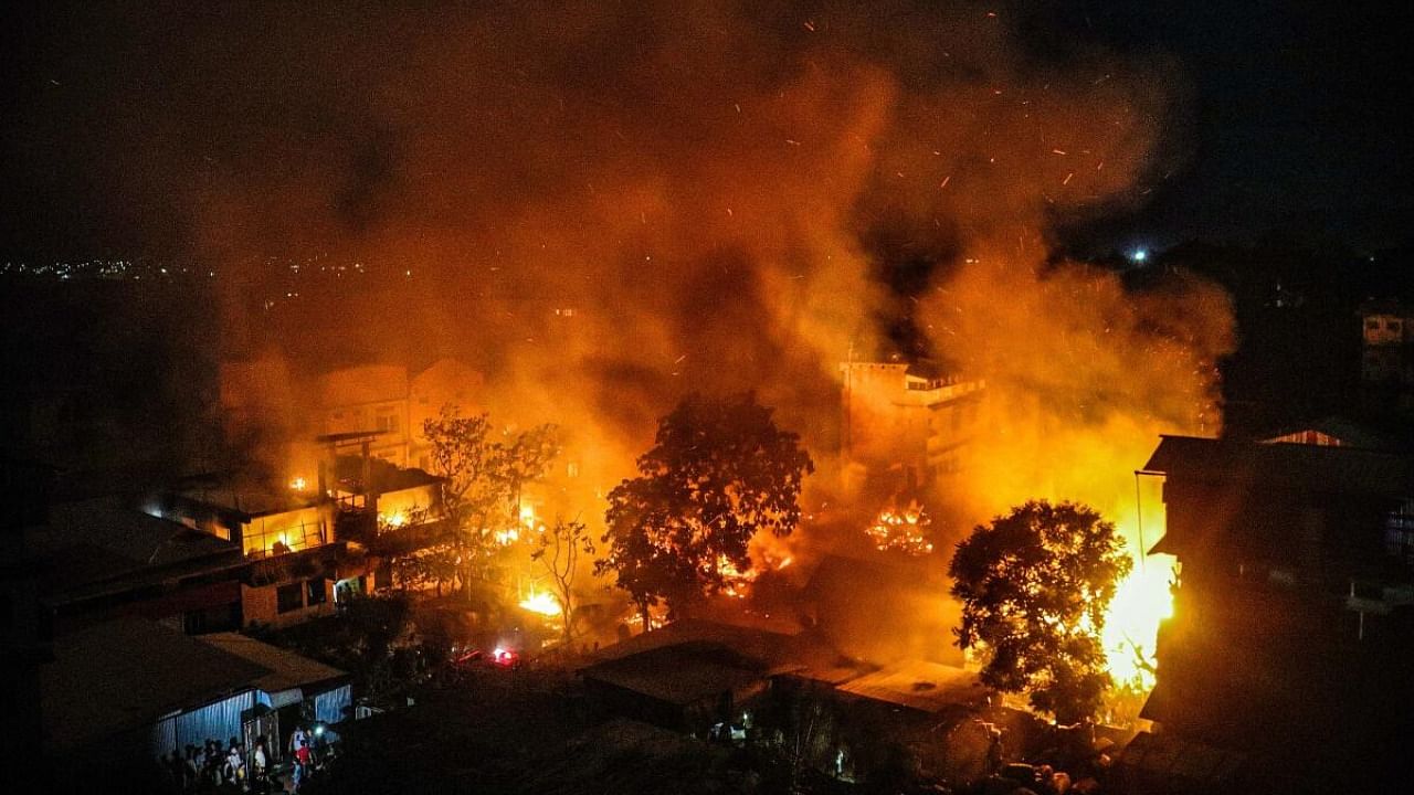 <div class="paragraphs"><p>Smoke and flame billows out after the houses of Kuki-Zo community were set on fire by miscreants in the violence-hit Manipur, in imphal, Tuesday, Aug 1, 2023. The fire also engulfed more than a dozen houses of migrants from Bihar, Haryana, and Naga people. </p></div>