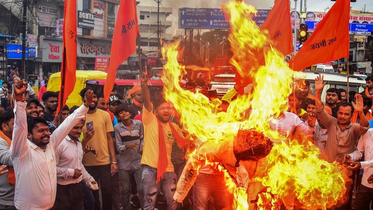  Vishva Hindu Parishad (VHP) and Bajrang Dal supporters burn an effigy during a protest against the violence in Haryana's Nuh district. Credit: PTI Photo