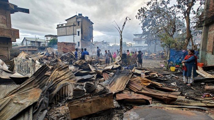 Imphal: Locals gather near Kuki-Zo community's houses which were burnt down by miscreants in the violence-hit Manipur, in imphal, Tuesday, Aug 1, 2023. Credit: PTI Photo 