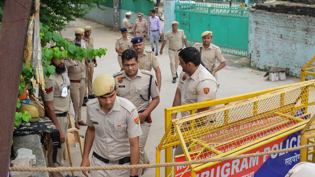  Police personnel stand guard during Friday prayers at Rajiv Chowk Masjid after the recent communal violence in parts of Haryana, in Gurugram, Friday, Aug. 4, 2023. Credit: PTI Photo