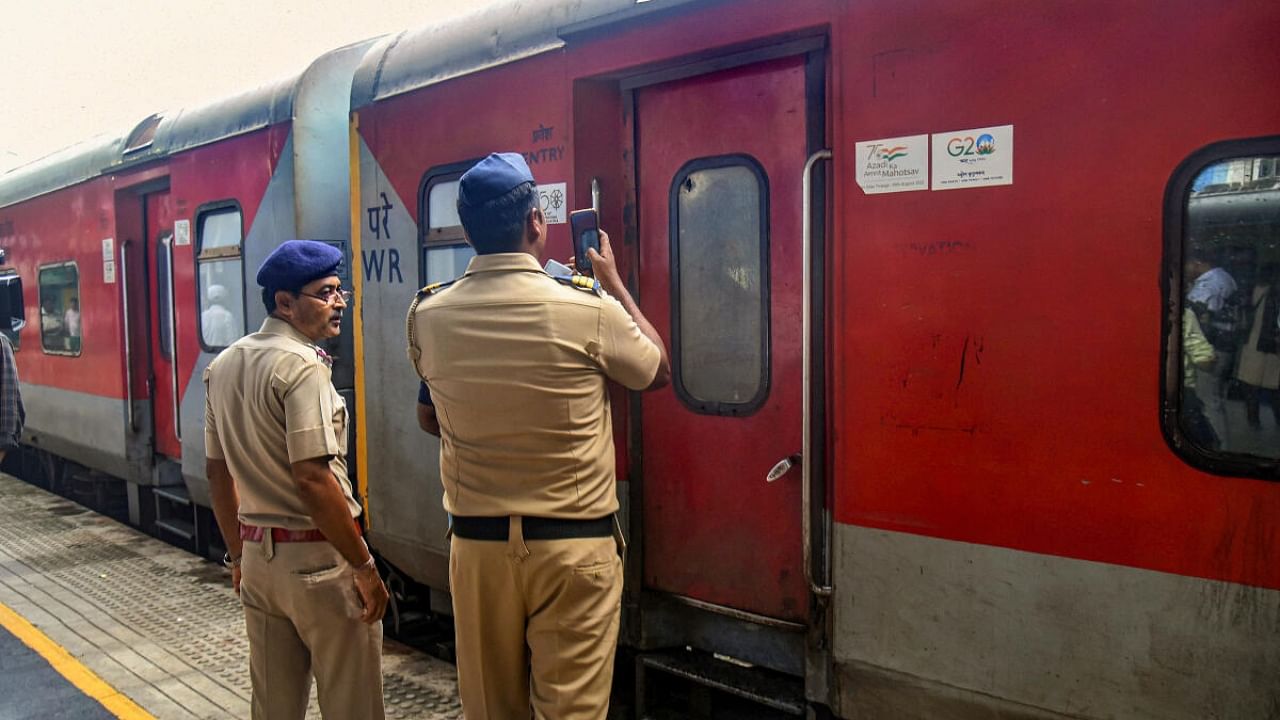 Police personnel inspect the Jaipur-Mumbai Central Express on board which a Railway Protection Force (RPF) jawan shot dead four people near Palghar railway station, in Mumbai. Credit: PTI Photo