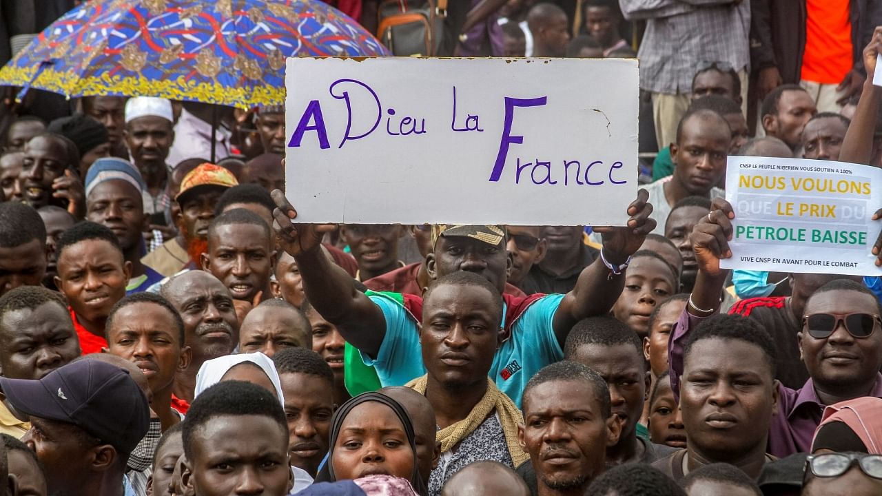 Thousands of anti-sanctions protestors gather in support of the putschist soldiers in the capital Niamey, Niger August 3, 2023. The sign reads "Goodbye france". Credit: Reuters Photo