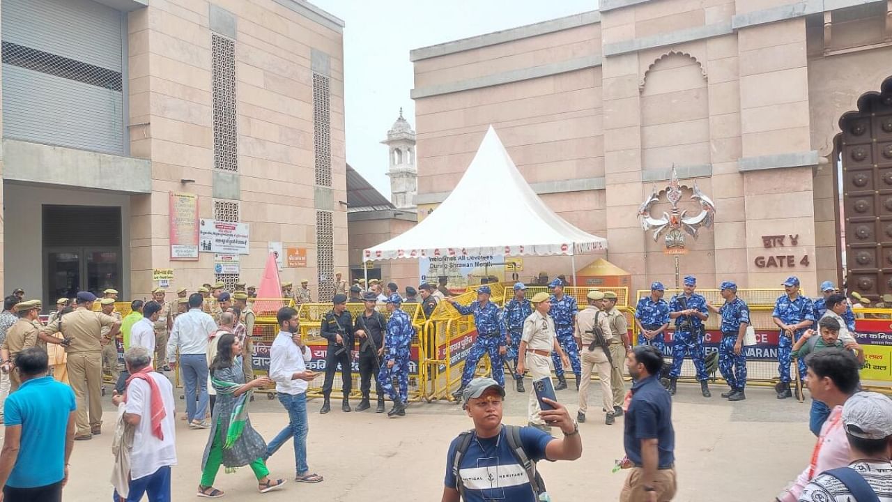 Security personnel stand guard outside the Gyanvapi mosque as a team of the Archaeological Survey of India (ASI) conducts a scientific survey at the mosque complex, in Varanasi. Credit: PTI Photo