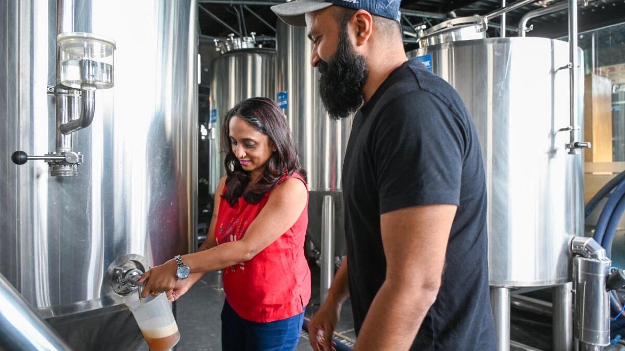 Beer is drawn from the tanks for tests during the brewing process. Credit: DH Photo