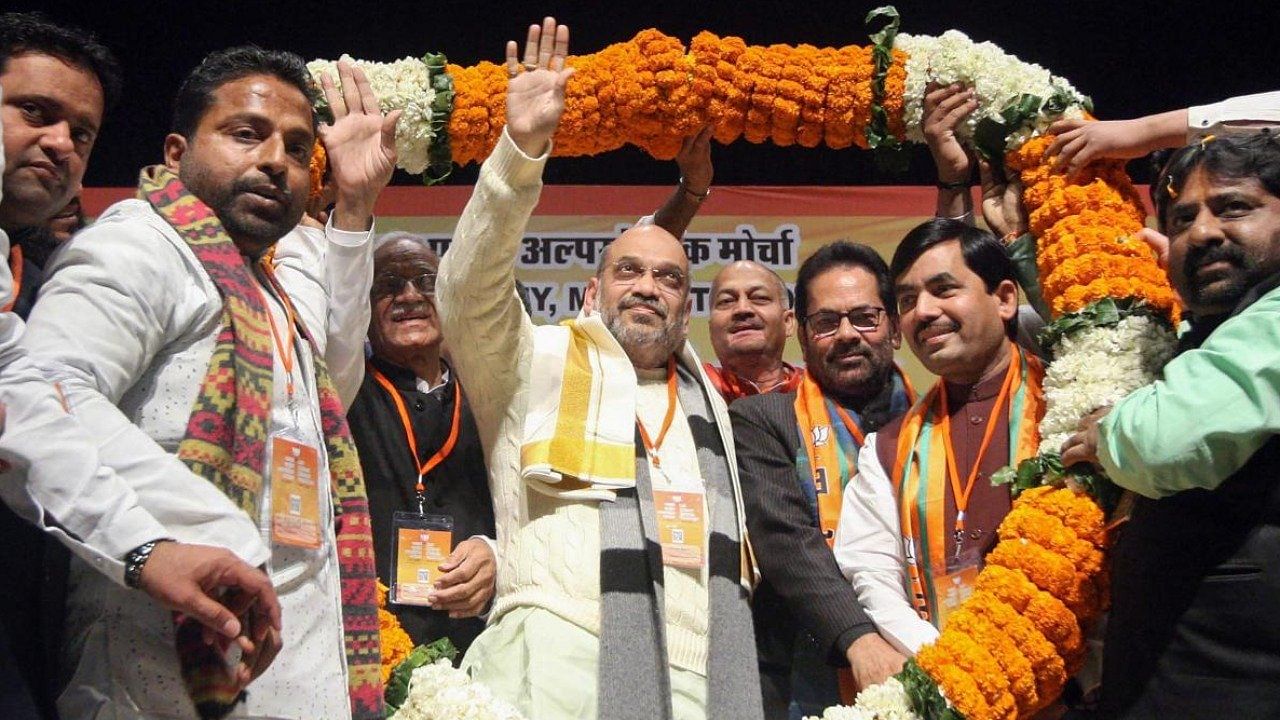 File photo of Home Minister Amit Shah being garlanded during Muslim Minority Sammelan, in New Delhi. Credit: PTI File Photo