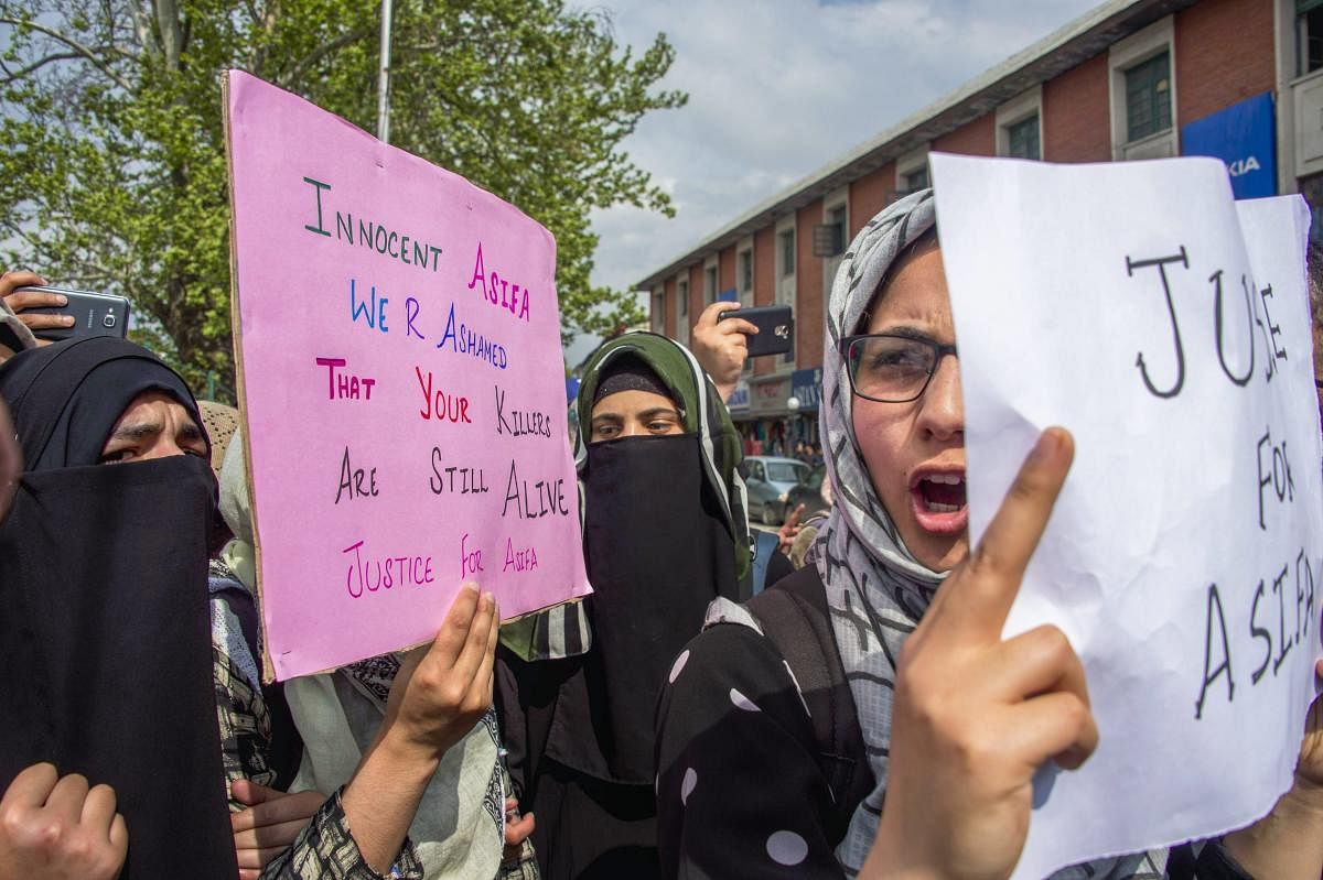 Students hold placards and shout slogans during a protest against the rape and murder of a 8-year-old girl in Kathua, in Srinagar on Monday. PTI