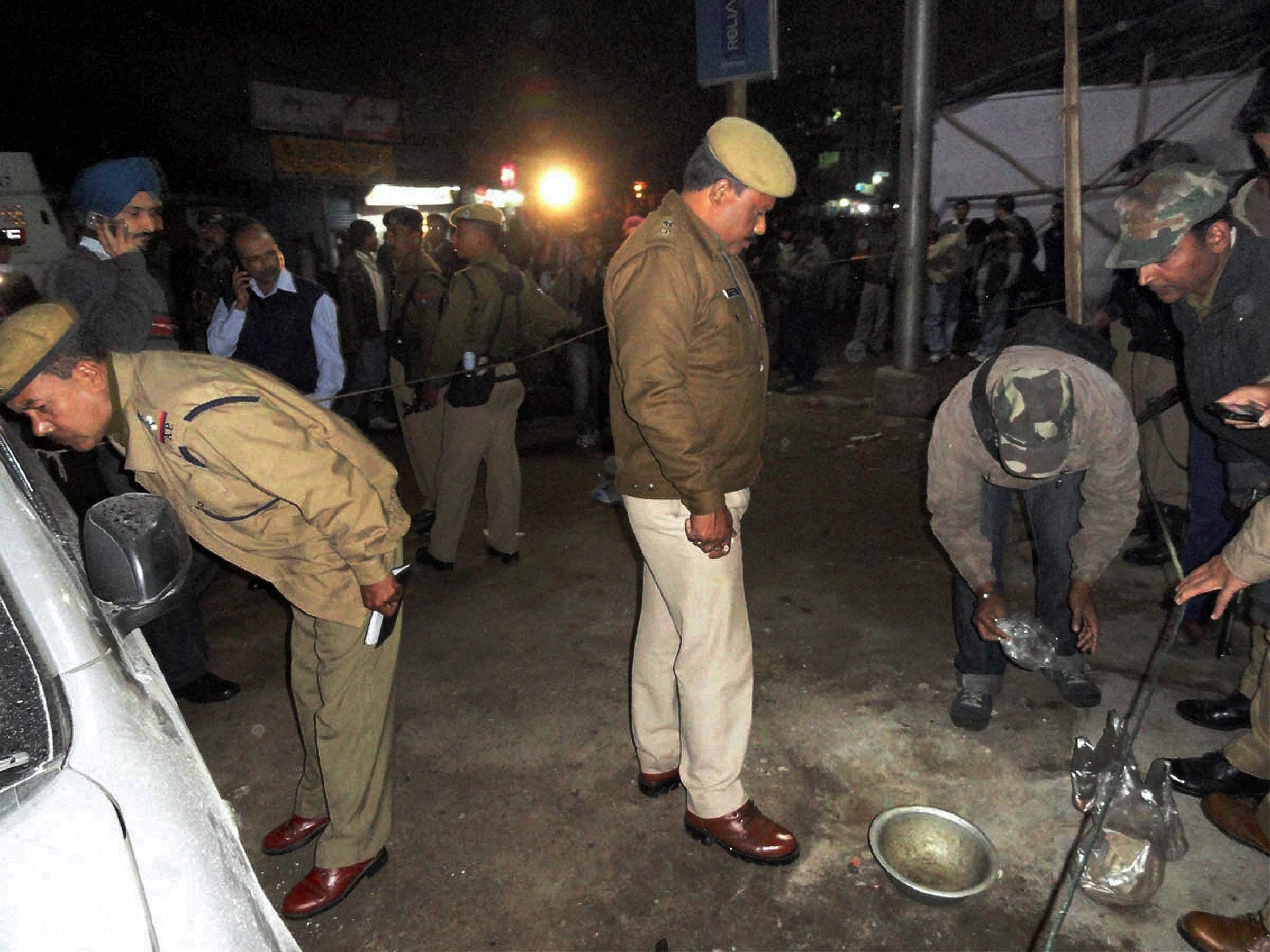 Police personnel searching for clues after suspected ULFA militants hurled a handgrenade at a busy market place in upper Assam's Tinsukia town on Monday.