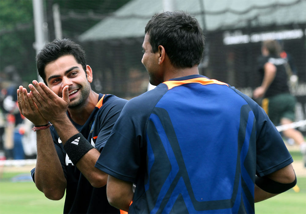 India's Twenty20 international cricket players Virat Kohli, left, and  Praveen Kumar enjoy a light moment during net practice in Sydney,  Australia,  Tuesday, Jan. 31, 2012. AP Photo