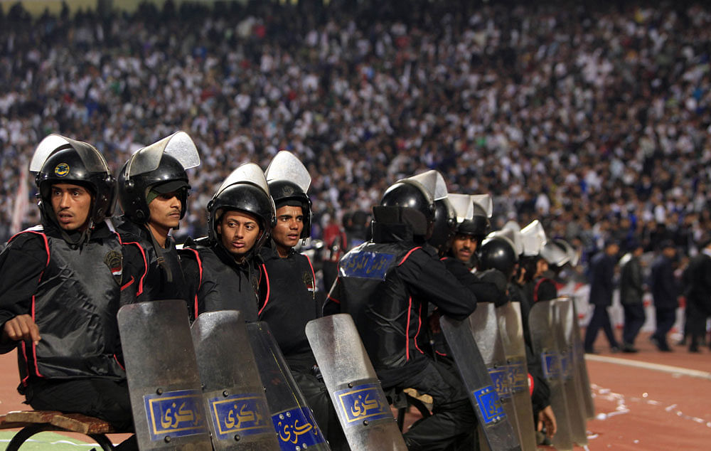 Egyptian riot police stand guard in Cairo Stadium during the first half of a match between Zamalek and Ismaili clubs in Cairo  on February 1, 2012.  At least 73 people were killed in fan violence  after a football match between Al-Ahly and Al-Masry c...