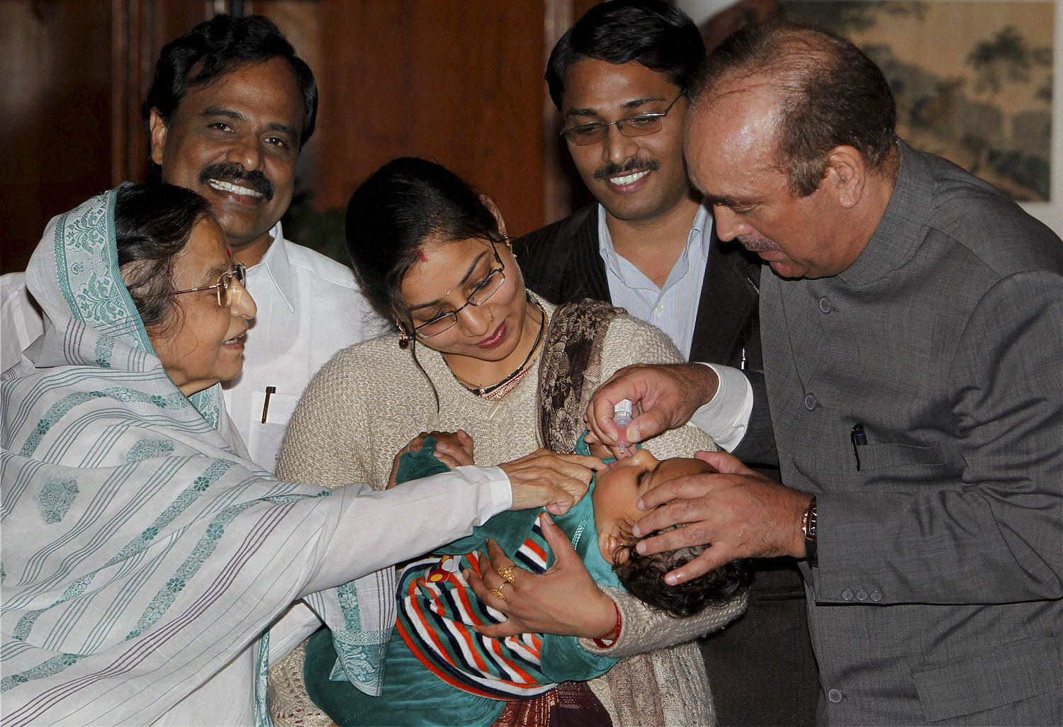 President Pratibha Patil and Health Minister Ghulam Nabi Azad administering polio drop to an infant on the eve of Pulse Polio Immunisation programme day in New Delhi on Saturday 18 Feb 2012. PTI Photo 