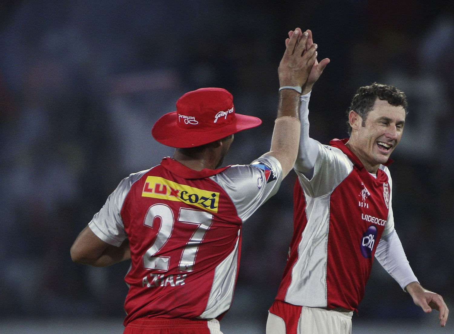 Kings XI Punjab bowler David Hussey, right, with Azhar Mahmood, celebrates the wicket of Deccan Chargers Cameron White during their Indian Premier League (IPL) cricket match in Hyderabad on Tuesday. AP