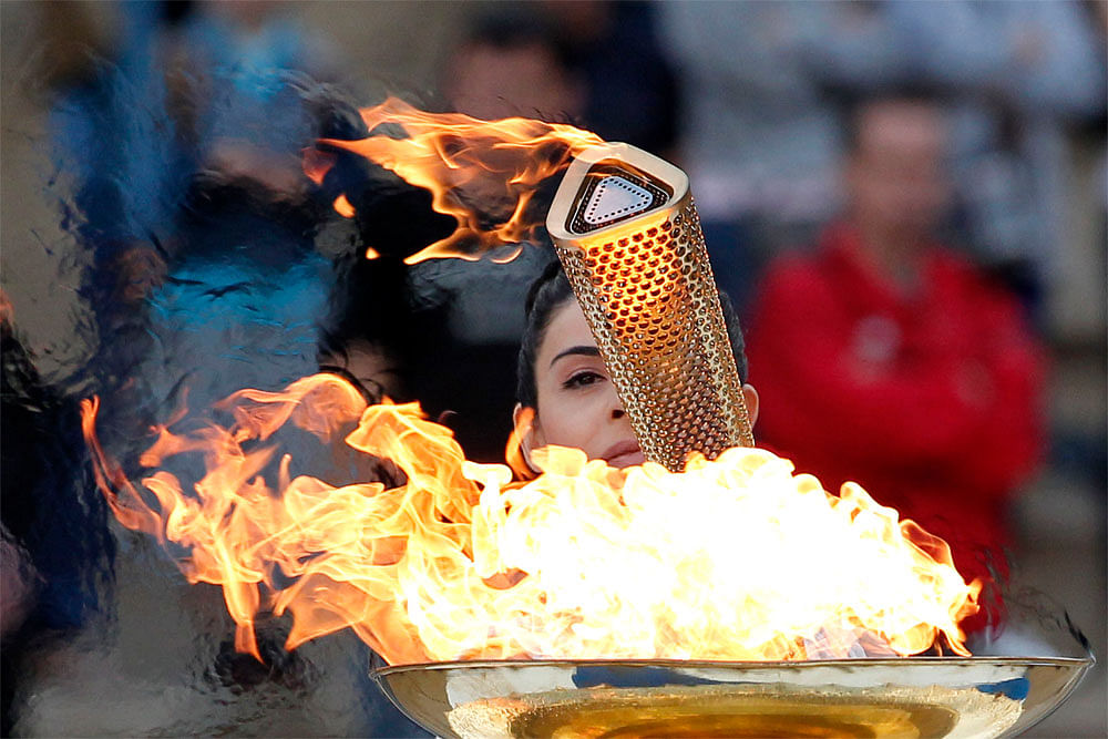 Actress Ino Menegaki, dressed as a high priestess, lights the torch at a  ceremony in Panathinean stadium in Athens, Thursday, May 17, 2012. The  torch begins its 70-day journey to arrive at the opening ceremony of the  London 2012 Olympics, from the...