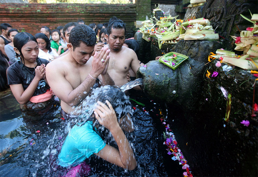 Balinese Hindus take a bath in holy water during Banyu Pinaruh, a  procession which Hindus celebrate to purity themselves and pray for  wisdom and wits, in Tampaksiring, Bali, Indonesia, Sunday, June 17,  2012. AP Photo