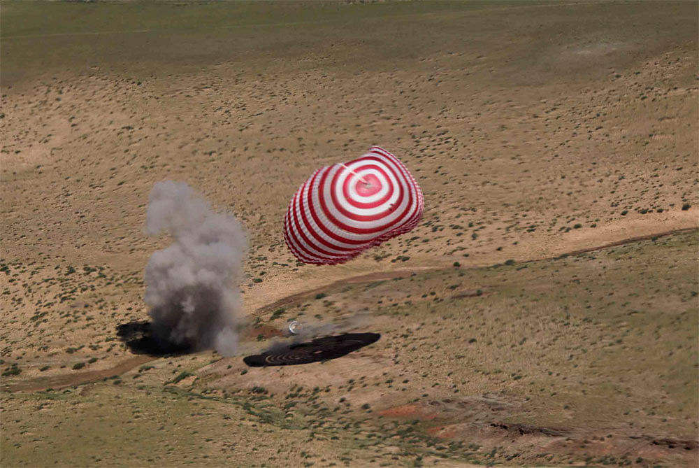 In this photo released by China's Xinhua News Agency, the re-entry capsule of China's Shenzhou 9 spacecraft lands safely in Siziwang Banner of north China's Inner Mongolia Autonomous Region Friday, June 29, 2012. The Chinese space capsule with three ...