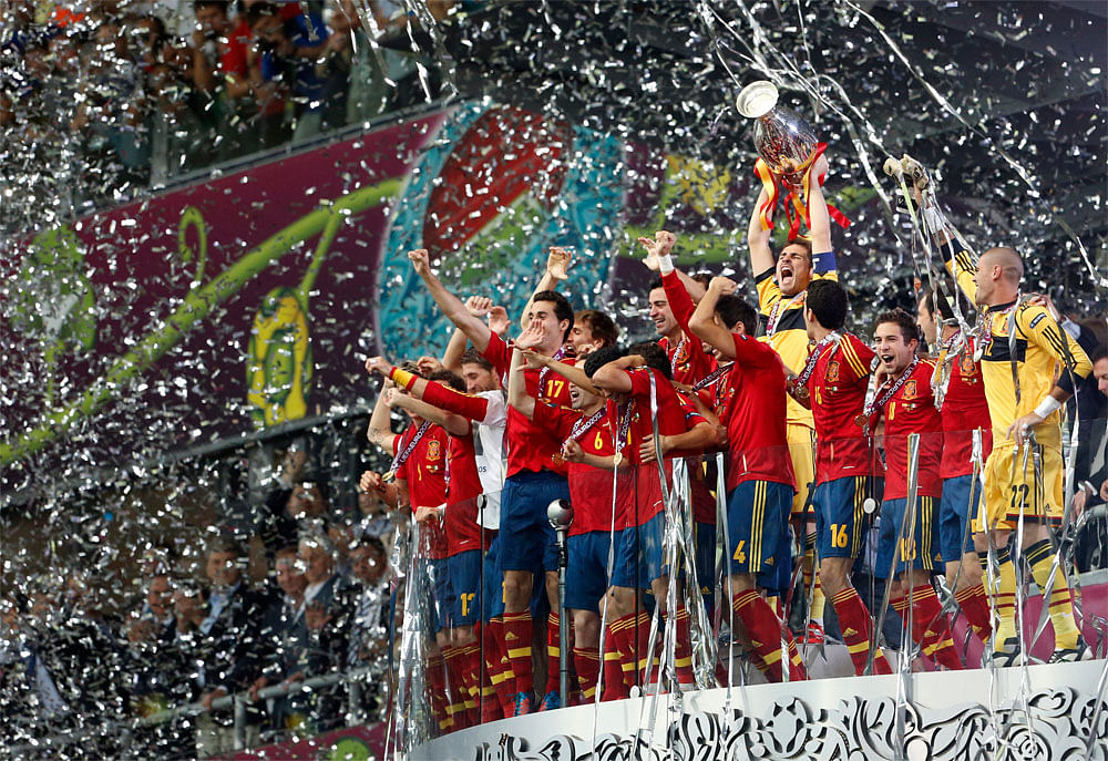 Spanish players celebrate with the trophy after the Euro 2012 soccer  championship final  between Spain and Italy in Kiev, Ukraine, Sunday,  July 1, 2012.AP Photo