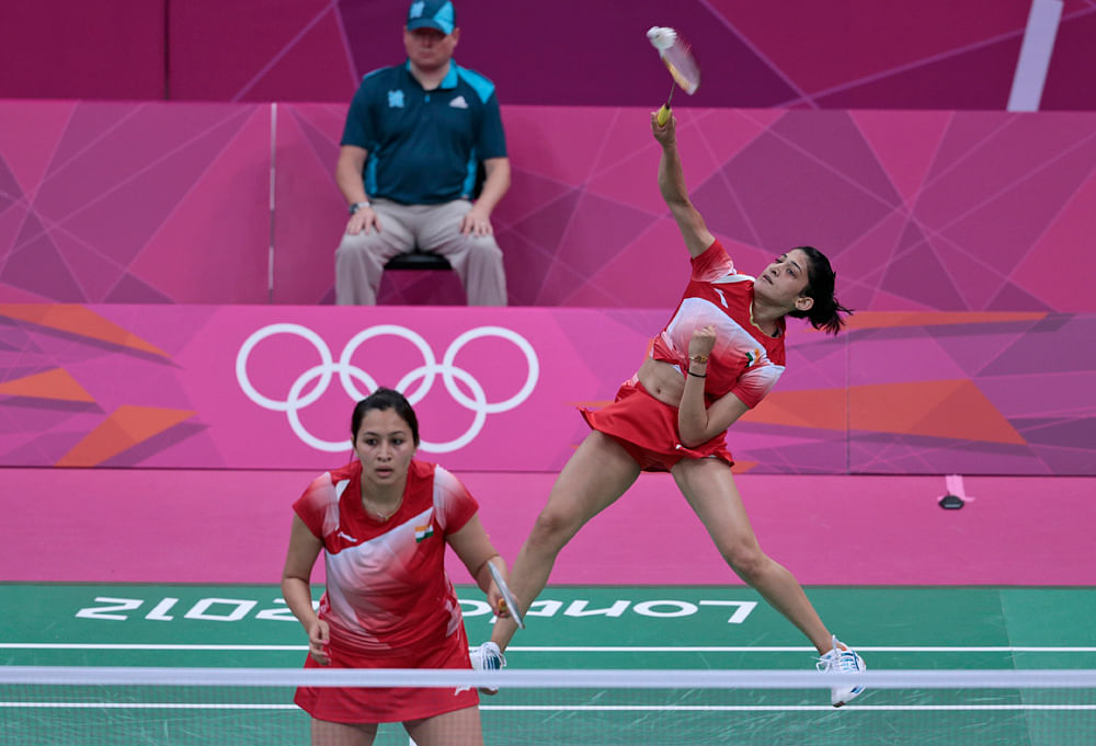 India's Ashwini Ponappa, right, and Jwala Gutta, play against Singapore's Sari Shinta Mulia and Yao Lei, unseen, at a women's doubles badminton match of the 2012 Summer Olympics, Tuesday, July 31, 2012, in London. AP