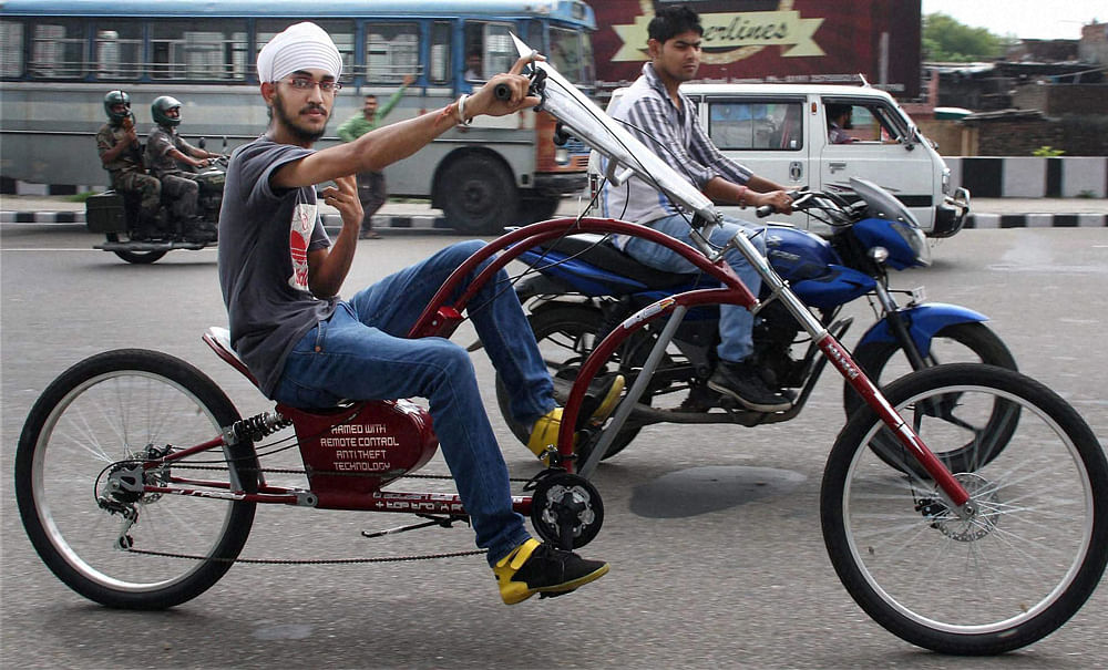 A student takes a ride in a cycle designed by himself in Jammu on Tuesday. PTI