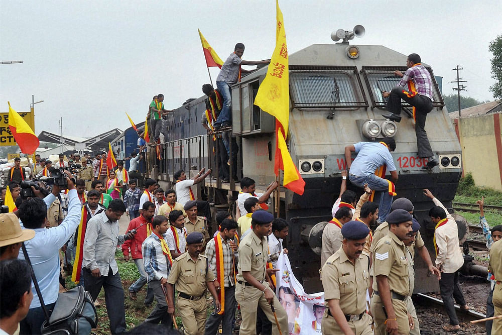 Hubli: Karnataka Rakshana Vedike stop a train during a protest over Cauvery water issue in Hubli on Saturday. PTI Photo