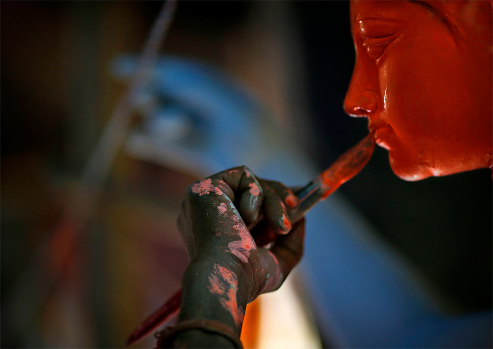 An artist paints idols of Hindu warrior goddess Durga, who destroys demons to prevail over evil, in New Delhi, India, Monday, Oct. 8, 2012. The festival of Durga will be celebrated from Oct. 20-24, 2012.(AP Photo/Saurabh Das)