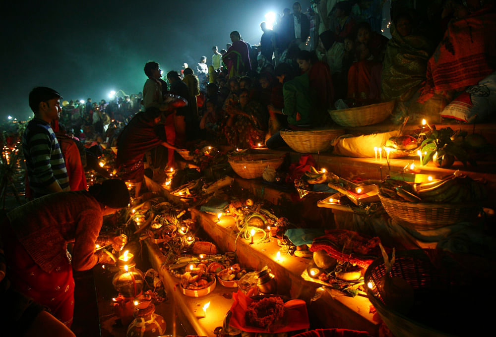 Hindu devotees prepare to offer prayers to the Sun god during the Hindu  religious festival 'Chhat Puja' at dawn, in the northern Indian city of  Chandigarh November 20, 2012. Hindu devotees worship the Sun god and  fast all day for the betterment of...