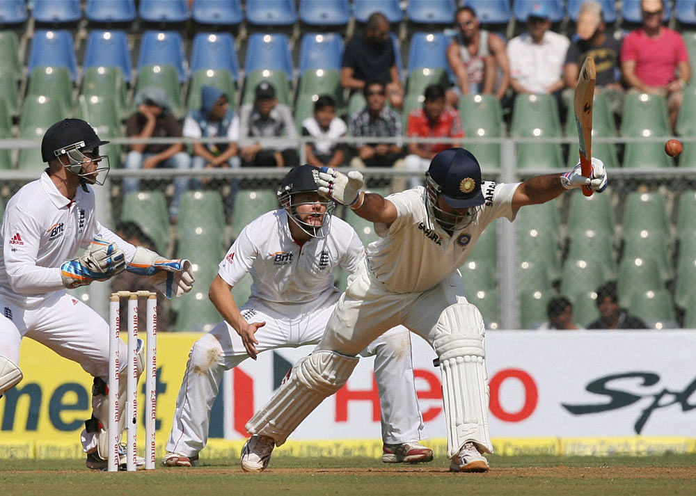 M S Dhoni plays a shot during the first day of second India-England Test match at Wankhade Stadium in Mumbai on Friday. PTI