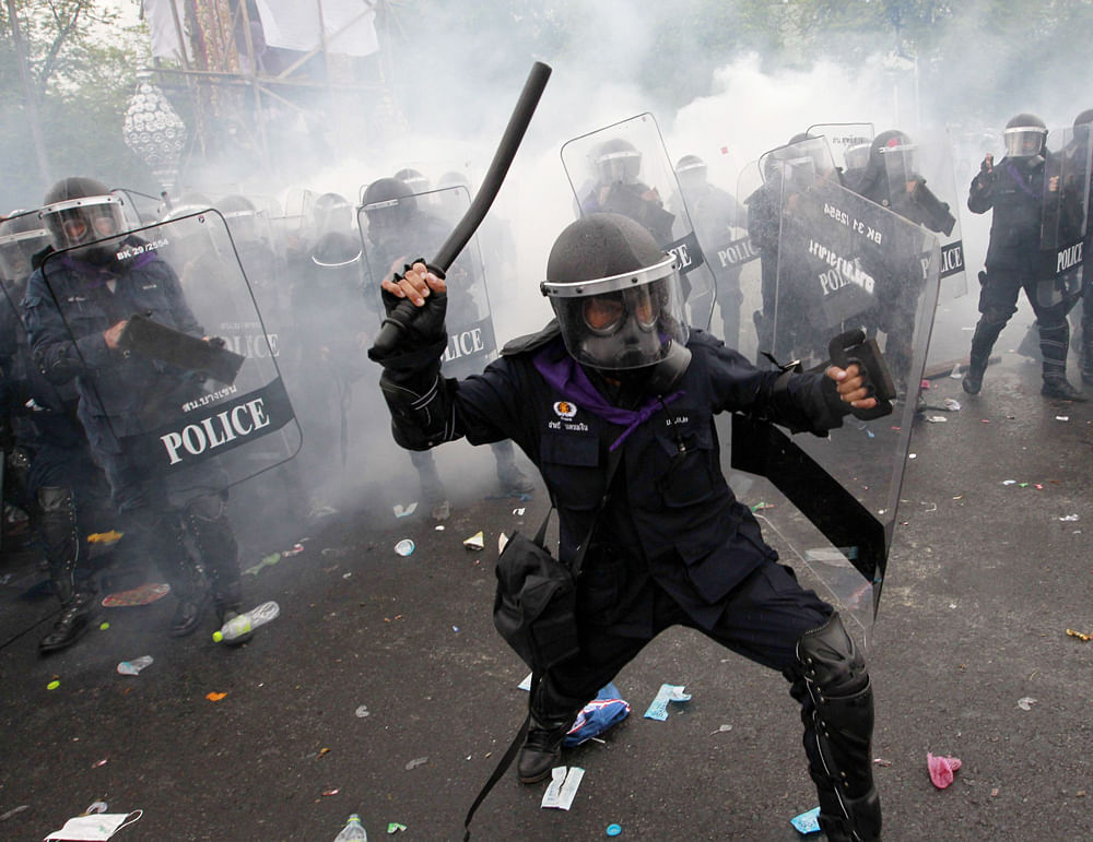 Tear gas is thrown as police scuffle with anti-government protesters in Bangkok November 24, 2012. Thai police fired tear gas in clashes with hundreds of protesters in Bangkok on Saturday ahead of a rally seeking to overthrow the government of Prime ...