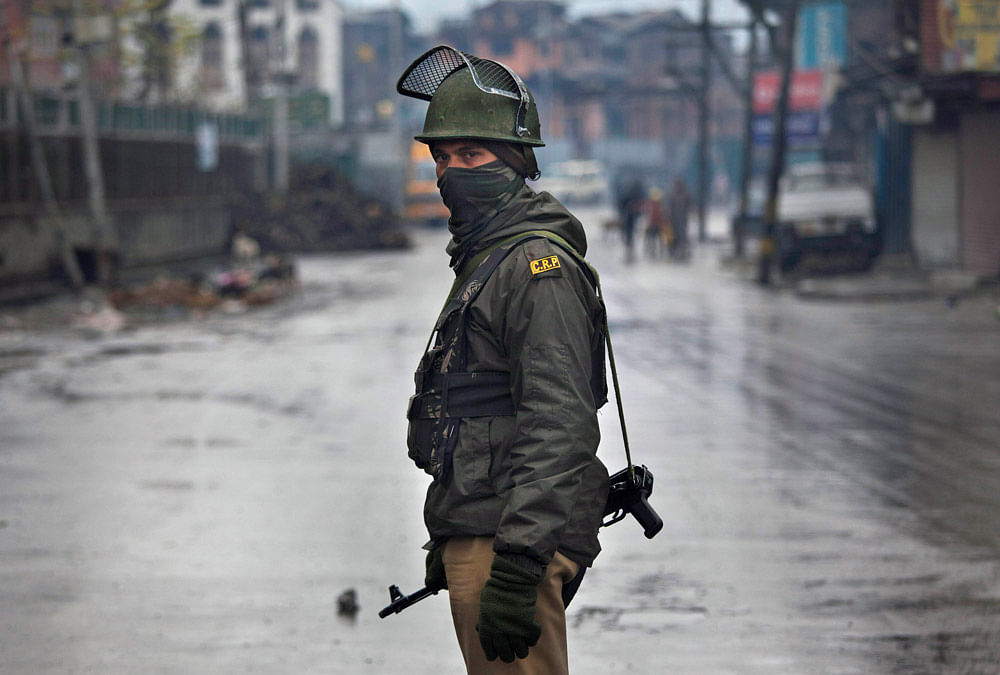An Indian paramilitary soldier stands guard at a temporary check point during curfew in Srinagar, India, Thursday, Nov. 29, 2012. Authorities in the Indian portion of Kashmir on Thursday imposed an indefinite curfew in most parts of Srinagar to avoid...