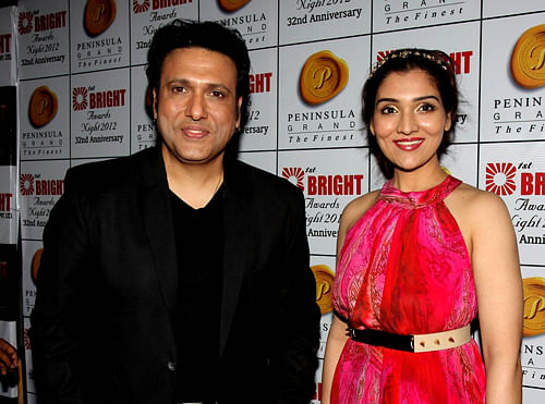 Bollywood actor Govinda (L) with his daughter Narmada attend the Bright Awards in Mumbai on December 11, 2012. AFP PHOTO