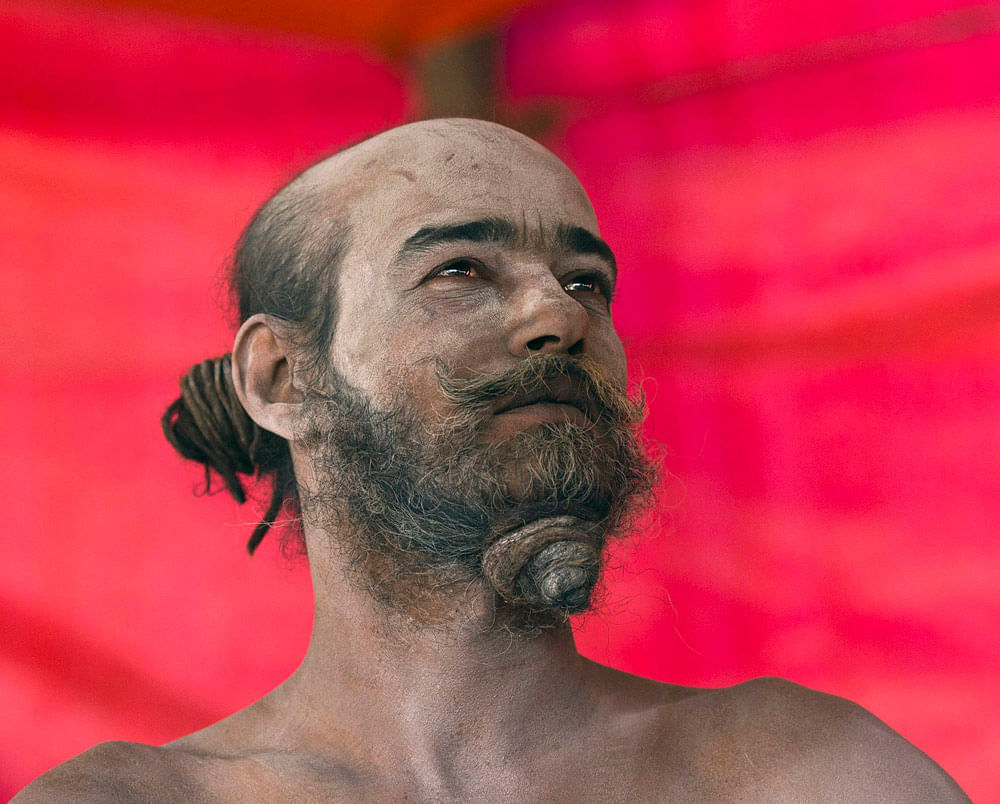 A Sadhu or Hindu holy man sits inside a tent near the banks of the river  Ganges during the ongoing 'Kumbh Mela', or Pitcher Festival, in the  northern Indian city of Allahabad January 15, 2013. During the festival,  hundreds of thousands of Hindus t...