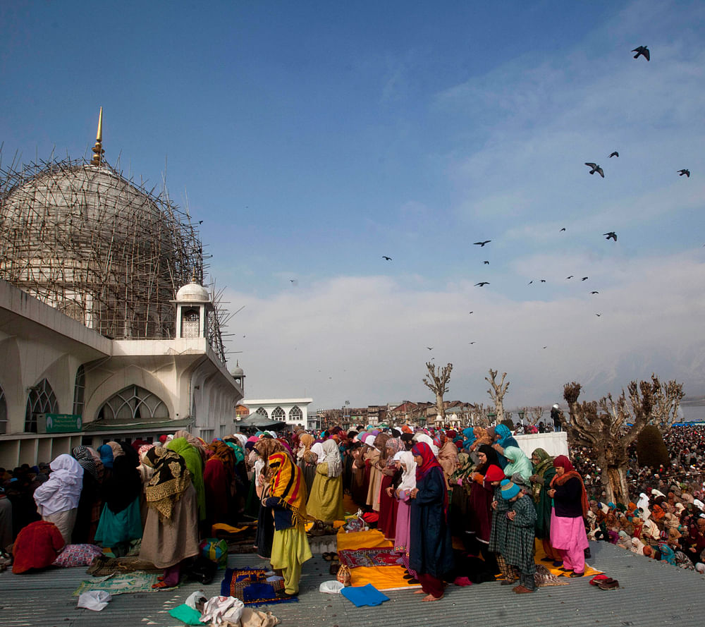 Kashmiri Muslims offer prayers at Hazratbal shrine on the birth anniversary of Prophet Muhammad in Srinagar, India, Friday, Jan. 25, 2013. Thousands of Kashmiri Muslims thronged the Hazratbal shrine, which houses a relic believed to be a hair from th...
