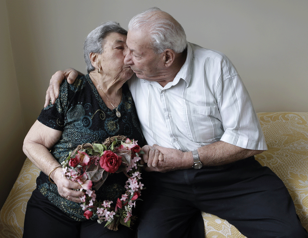 Madalena, 88, and Fortunato Corso, 89, a Bensonhurst couple married 72 years prepare for Valentine's Day with a kiss at home in New York, Wednesday, Feb. 13, 2013. On Thursday they'll be honored by Brooklyn borough President Marty Markowitz in a cele...