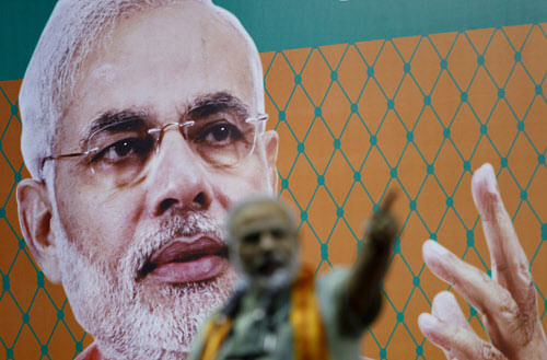 BJP leader Narendra Modi speaks in front of his life size portrait during a campaign rally for the upcoming state elections in Bangalore on Sunday, April 28, 2013. Karnataka will go to the polls on May 5, 2013. There are 41.8 million voters in the st...